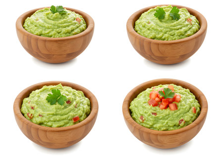 Wooden bowls filled with green guacamole dip isolated on white backgroundの素材