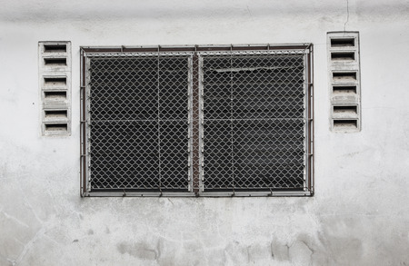 front aged glass of windows and wood frame on grunge wallの写真素材