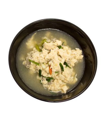 Fried Eggs in Clear Soup in black bowl on white backgroundの写真素材