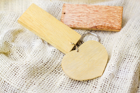 wood key chain on white fabricの写真素材