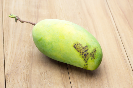 green mango on wooden boardの写真素材
