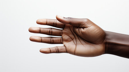 A delicate hand with perfectly manicured nails, adorned with sign language symbols, grips a cherished object between its thumb and fingerの素材