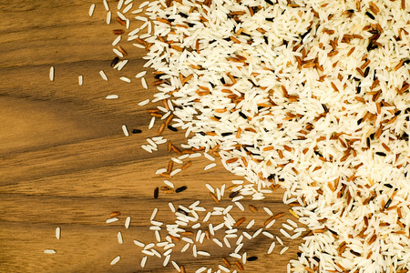 Red, Black, and White Rice on Wooden tableの写真素材
