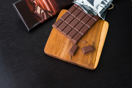 Pack of Dark chocolate bar on the cutting boardの写真素材
