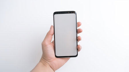Smartphone mockup with blank screen in hand isolated on white backgroundの素材