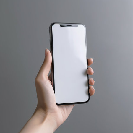 Smartphone mockup with blank screen in female hand on gray backgroundの素材