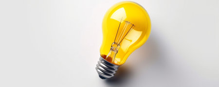 Yellow light bulb on a white background. The concept of idea and innovation.の素材