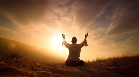 Relaxed woman meditating on the top of a mountain during sunset  praying for GOD conceptの素材