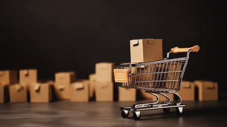 Shopping cart with boxes on black background. Online shopping concept.の素材