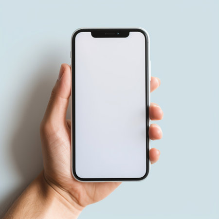 male hand holding smartphone with blank screen on blue background, mockupの素材
