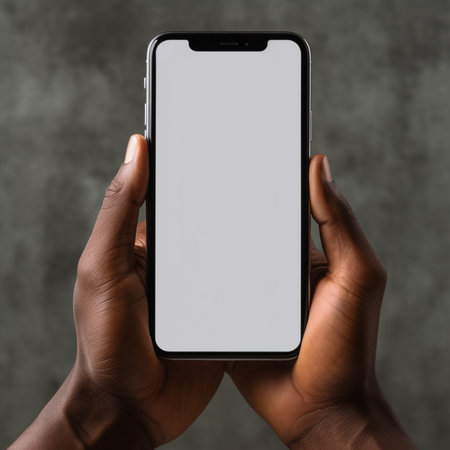 Mockup image of hands holding mobile phone with blank white screenの素材