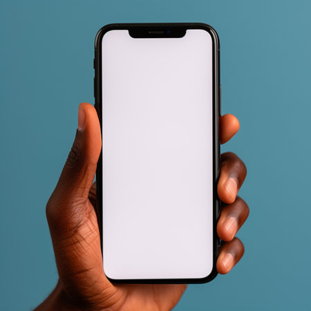 male hand holding smartphone with blank screen on blue background, mockupの素材