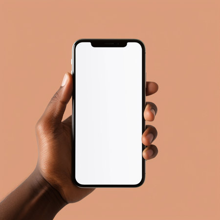 Smartphone mockup with blank screen in hand, isolated on brown backgroundの素材