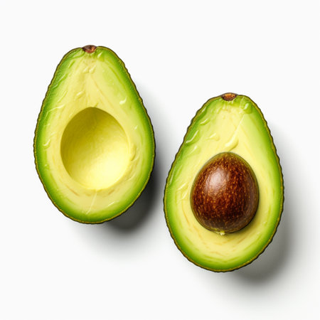 Avocado cut in half isolated on white background. Top view.の素材