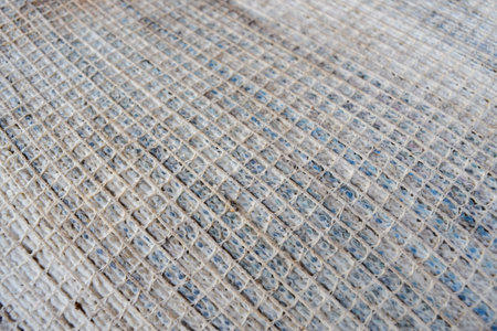square network of old carpet texture