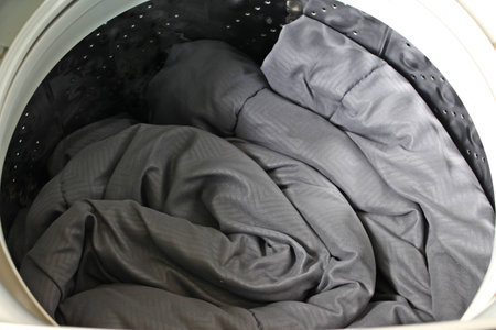 Roll up the duvet put in a washing machine.の写真素材