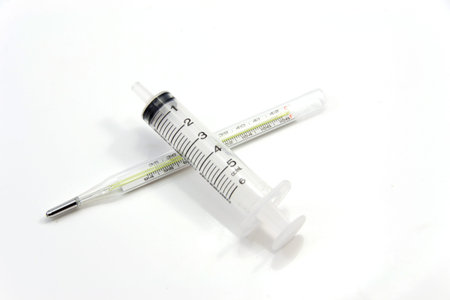 clinical thermometer and a syringe