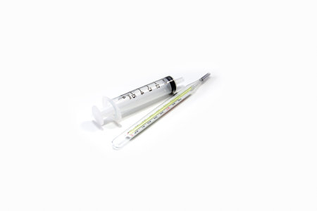 clinical thermometer and a syringe