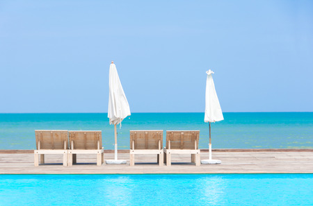 pool beside the sea with  umbrellasの写真素材