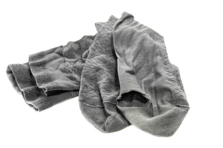 used dirty sock on a white backgroundの写真素材