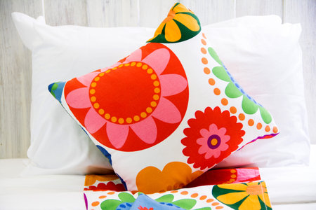 colorful pillow on a bed in a bedroom