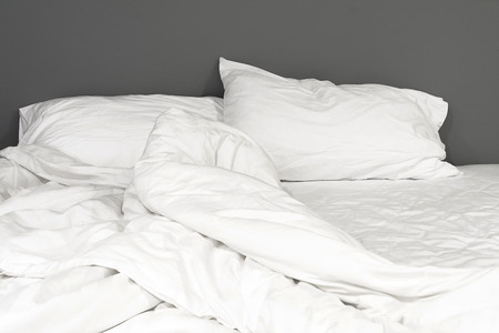 white messy unmade bedの写真素材