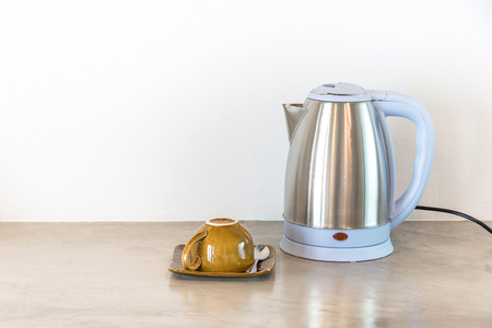 Metal electric kettle with brown cupの写真素材