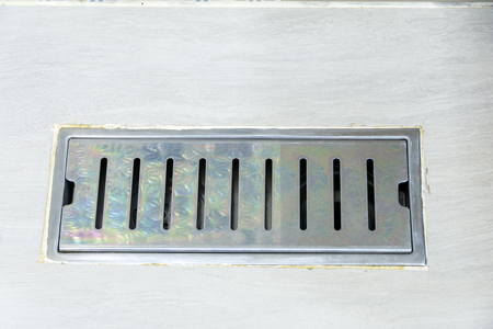 sewer cover in bathroomの写真素材
