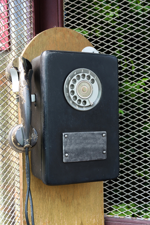 Antique Telephone Hang On Woodの写真素材