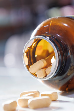 Pills are spilling out of a bottle.の写真素材