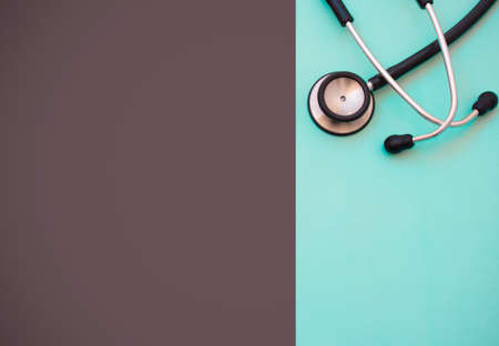 Black stethoscope for doctor diagnostic disease, medical tool for health on blue and black background with copy space. for text message or media and content.の写真素材