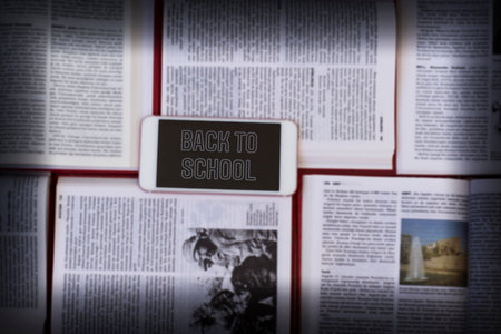 Welcome back to school background. Top view of a smart mobilephone over lot of opened books. Wisdom,...