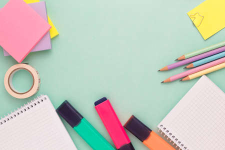 Top view of stationeries and office supplies on turquoise background. Back to school concept. copy space for your text message or media and content.の写真素材