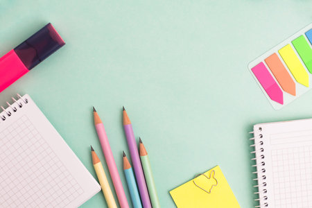 Top view of stationeries and office supplies on turquoise background. Back to school concept. copy...