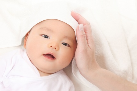 Hands of the mother and the baby boy of Asiaの写真素材