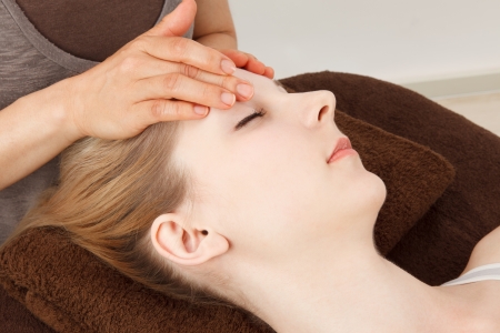 Beautiful young caucasian woman undergoing a massageの写真素材