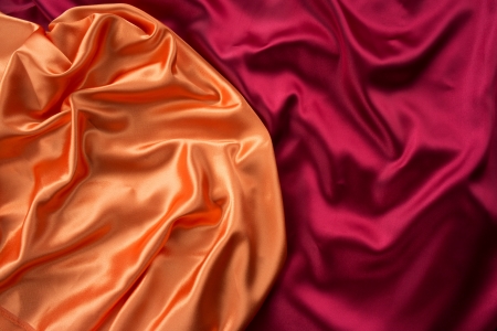 Smooth elegant orange and dark red silk can use as backgroundの写真素材