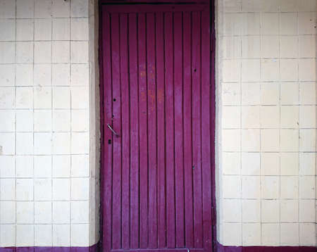 Medium-sized door texture background yellow tiles on the wall facade backgroundの写真素材