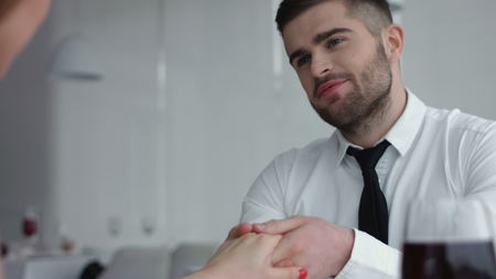 Young Couple Toasting champagne In Restaurant. Dating. Young man and woman on romantic dinner drinking at restaurant, celebrating valentine day.の写真素材