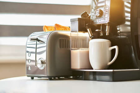 Aromatic coffee with golden toast for breakfast. Coffee is made on a professional coffee machine. Flat white with a large milk foamの写真素材