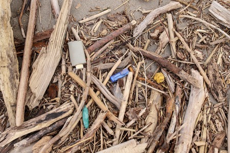 Environmental problem. Ecology concept. Plastic on the beach. Spilled garbage on the beach. Symbol of pollution and destruction of the planet.の写真素材