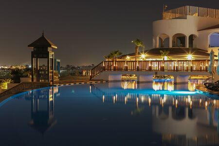 Sharm El Sheikh, South Sinai, Egypt - 05.18.2019.Night view to the swimming pool and palm trees on the beach near the red sea.の写真素材