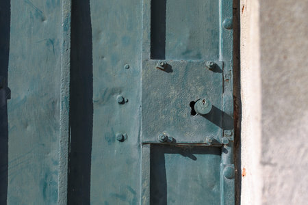 Old rusty metal lock and keyhole on a old iron door as a beautiful vintage background. Old rusty...
