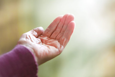Old ladys hand with open palm. Elderly lady is waiting for help. Elderly, Aging concept, with white...