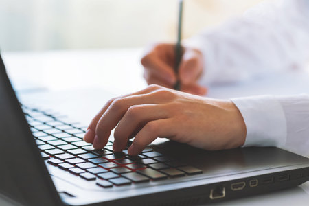 Female worker typing on the keyboard. Distance learning, education online. Online working from home,...
