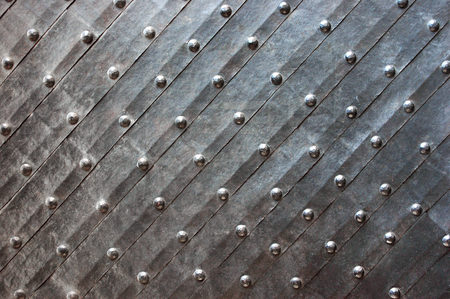 Medieval iron door with rivets as background.の写真素材