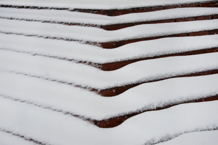Stony stairway covered with fresh snow, winter time.Texture of fresh snow on the stairs.の写真素材