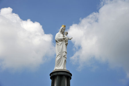 Statue of the Virgin Mary with little Jesus on the hands.の写真素材