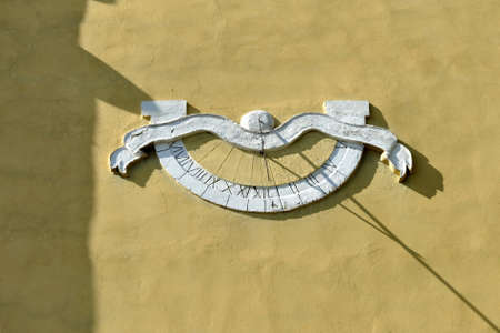 Old sundial on the reconstructed church wall.の写真素材