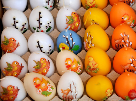 Traditional Easter decor. Paraffin candles in the shape of colorful eggs put up for sale. selective...